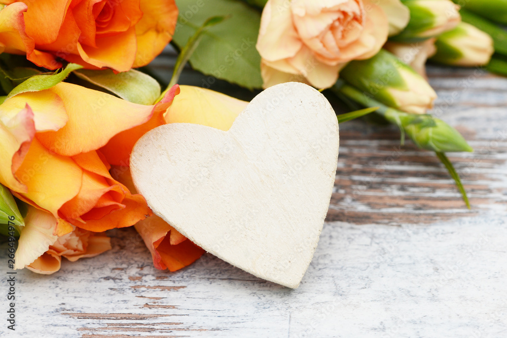 Heart, roses and carnation lying on wood Heart, roses and carnation lying on wood