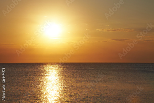 Sunset on the flat sea. Light reflection on the waves. © Simone
