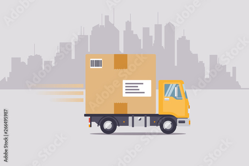Parcel delivery truck driving through cityscape