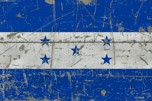 Grunge Honduras flag on old scratched wooden surface. National vintage background. © sezerozger