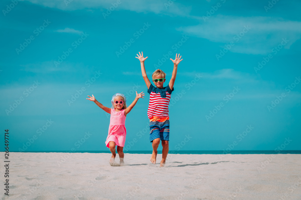 happy kids-little boy and girl- have fun on beach