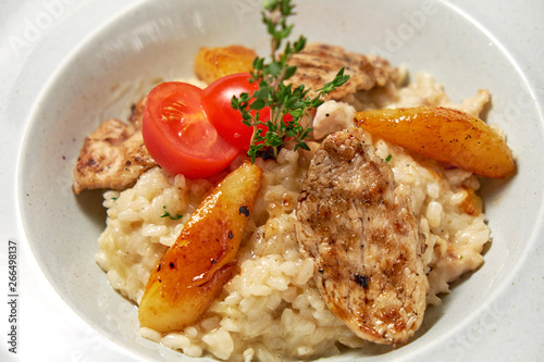 Grilled chicken with white rice. Light wooden background. Restaurant menu