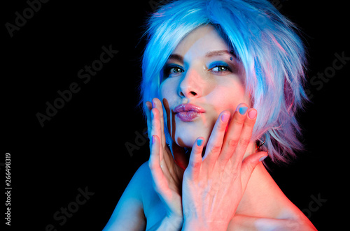 Portrait of beautiful girl with blue hair on black background