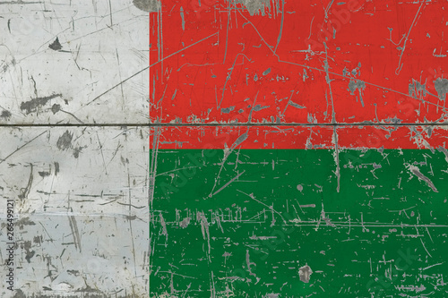 Grunge Madagascar flag on old scratched wooden surface. National vintage background. © sezerozger