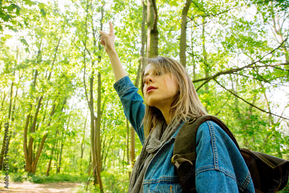 Young woman with backpack in a mixed forest Young woman with backpack in a mixed forest
