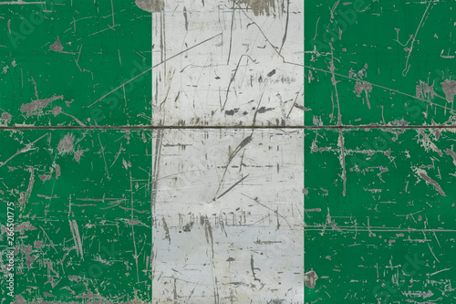 Grunge Nigeria flag on old scratched wooden surface. National vintage background. © sezerozger