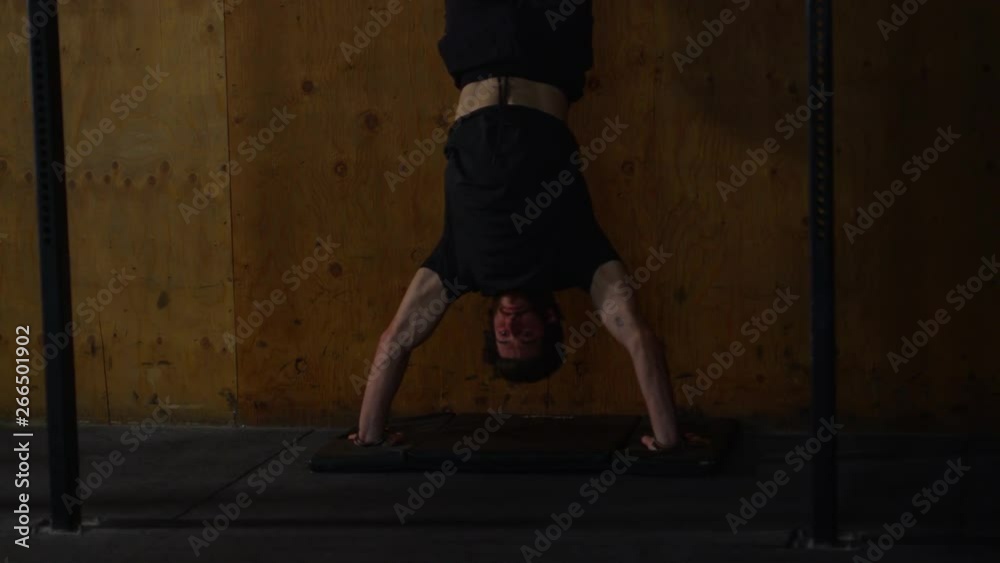 Young guy in crossfit gym working out Young guy in crossfit gym working out