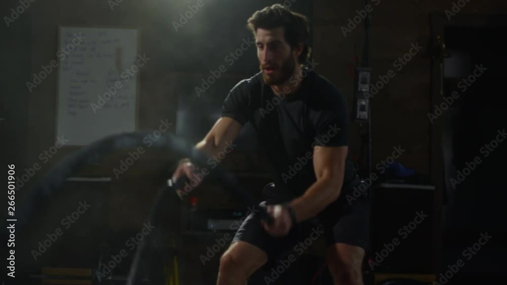 Young guy in crossfit gym working out Young guy in crossfit gym working out