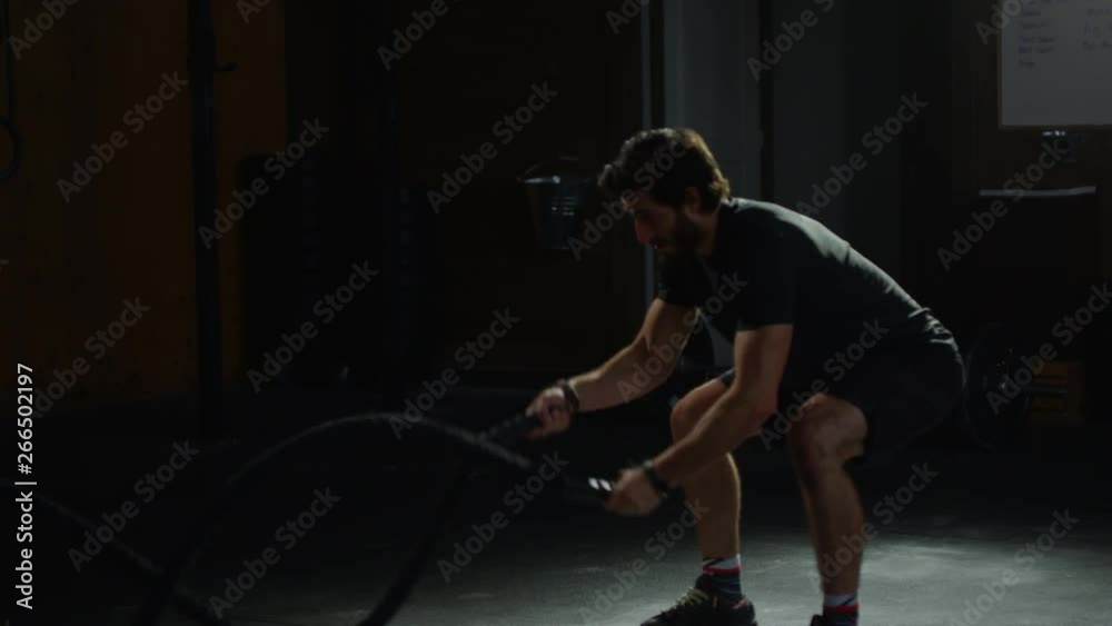 Young guy in crossfit gym working out Young guy in crossfit gym working out