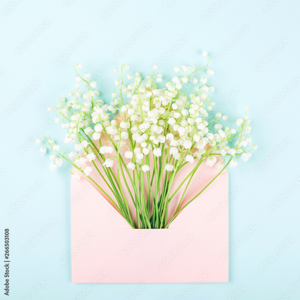 Bouquet of lily of valley in pink envelope.