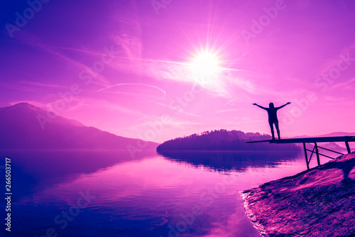 Figure of a man with open arms. Lake and mountains in trend colors. Plastic Pink, Proton Purple