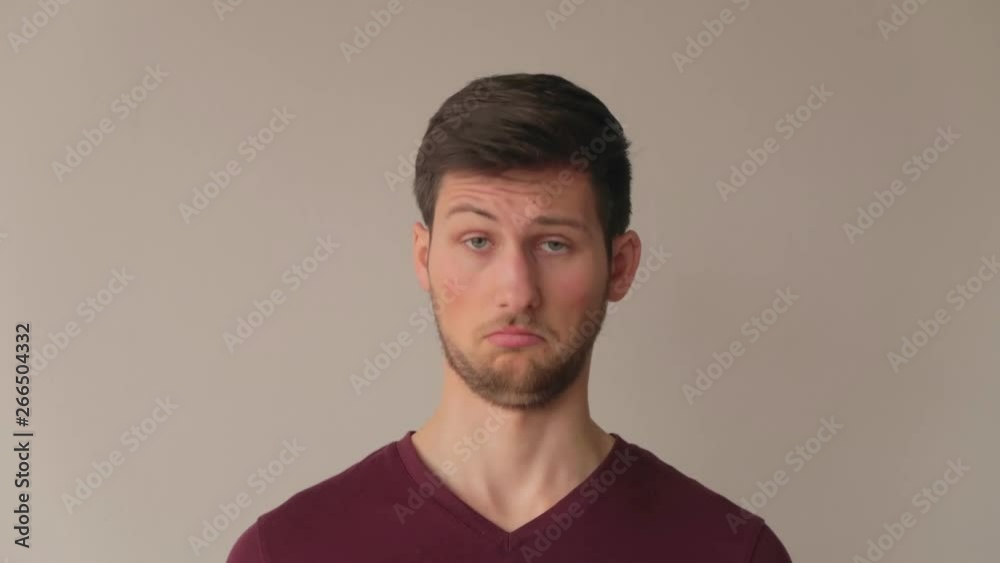 Young male model making surprised expressions and doubting, medium close-up facing camera still shot Young male model making surprised expressions and doubting, medium close-up facing camera still shot