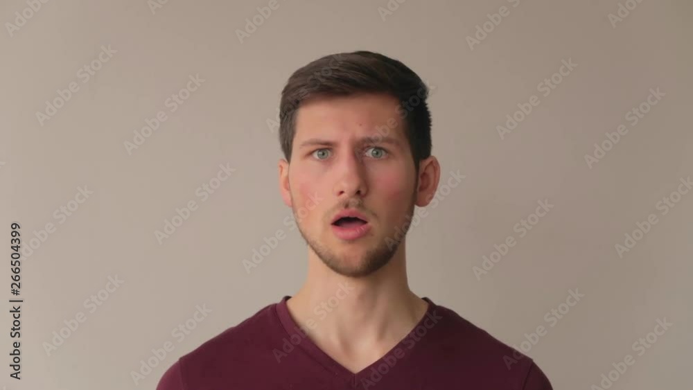 Young man being surprised and acting in negation with strong emotions, medium close-up facing camera still shot Young man being surprised and acting in negation with strong emotions, medium close-up facing camera still shot