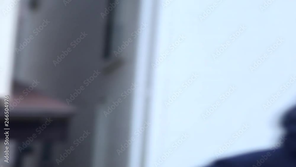 A man looks and checks both ways of the street and crosses. Front. Daytime. Camera pan, angle low, medium closeup shoot. 4K 24fps (TOKYO, JAPAN - 15th March 2019). A man looks and checks both ways of the street and crosses. Front. Daytime. Camera pan, angle low, medium closeup shoot. 4K 24fps (TOKYO, JAPAN - 15th March 2019).