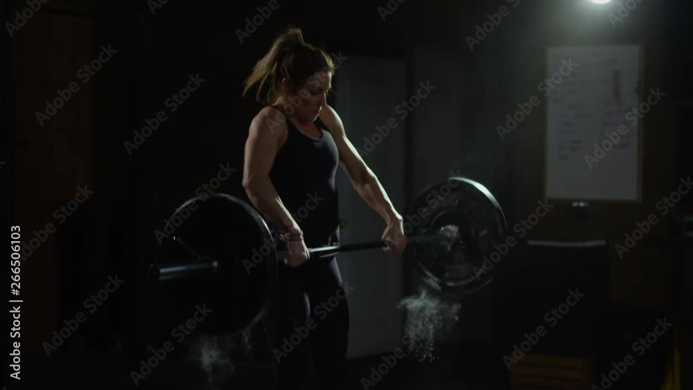 Young girl in crossfit gym working out