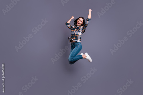Full length side profile body size photo beautiful yell she her lady hold raise hands arms raised flight air football match game wear casual jeans denim checkered plaid shirt isolated grey background
