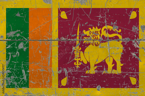 Grunge Sri Lanka flag on old scratched wooden surface. National vintage background.