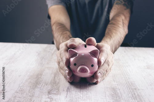 man holding a piggy bank