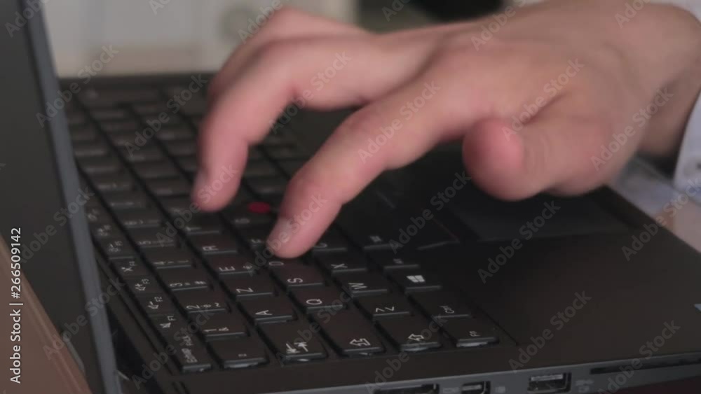 Hand typing on black laptop keyboard and using touchpad, still shot close-up Hand typing on black laptop keyboard and using touchpad, still shot close-up