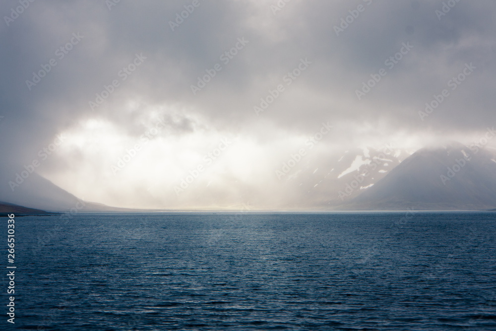 The mountains rise above the water column, with beautiful sunlight and haze The mountains rise above the water column, with beautiful sunlight and haze
