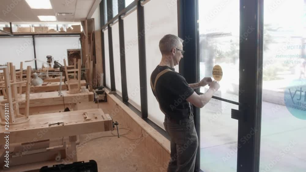 Woodworker opens and walks through wood shop Woodworker opens and walks through wood shop