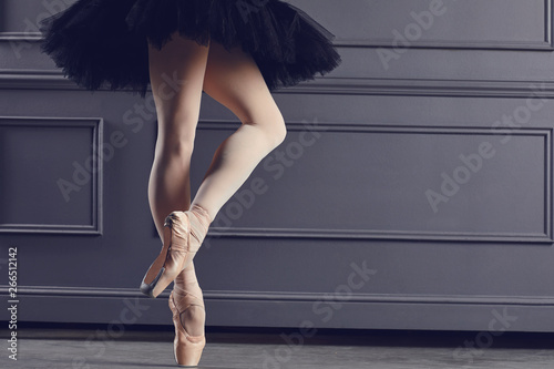 Legs of a ballerina on a black background. photo