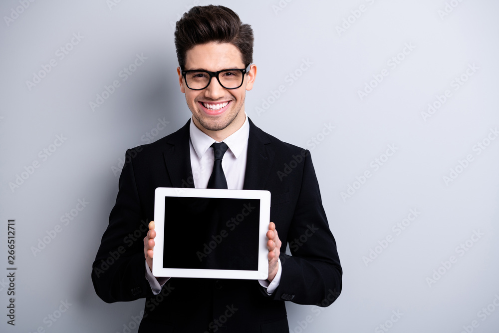 Portrait of his he nice classy attractive cheerful positive guy demonstrating holding in hands black display digital technology executive leader expert development isolated over light gray background Portrait of his he nice classy attractive cheerful positive guy demonstrating holding in hands black display digital technology executive leader expert development isolated over light gray background