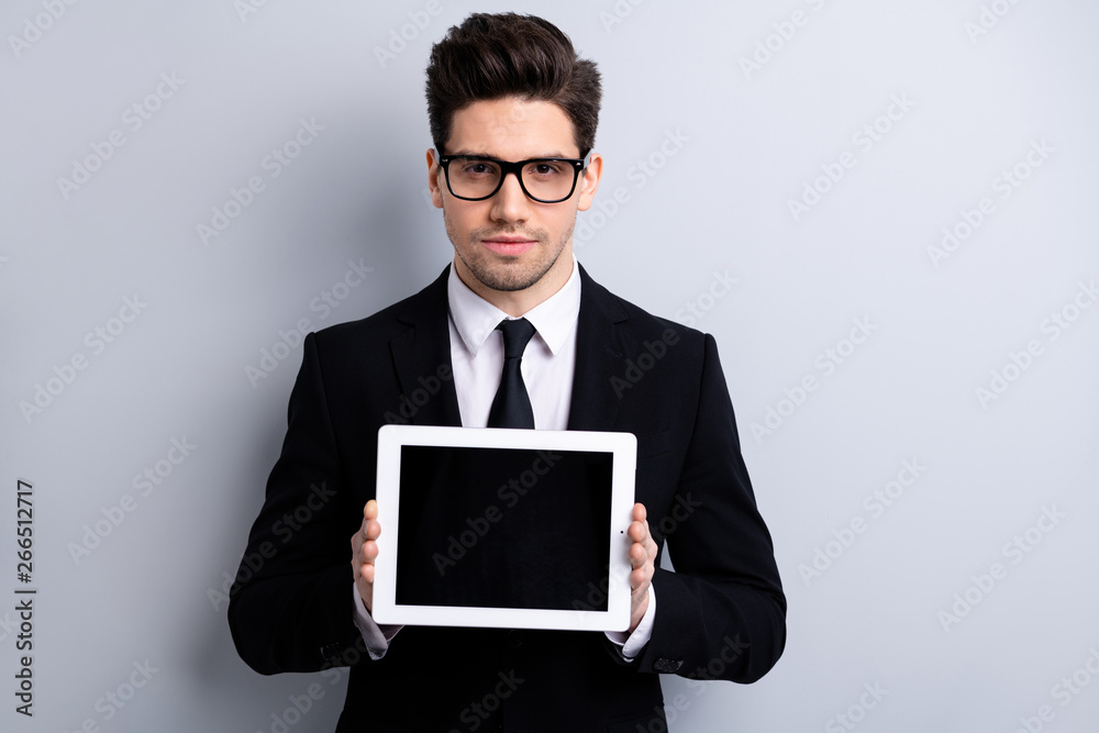 Portrait of his he nice classy attractive guy demonstrating holding in hands black display digital technology recommend executive leader expert development isolated over light gray background
