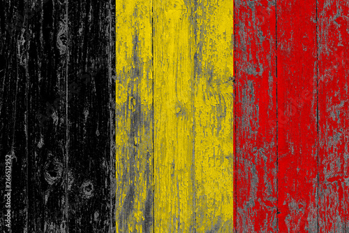 Flag of Belgium painted on worn out wooden texture background.