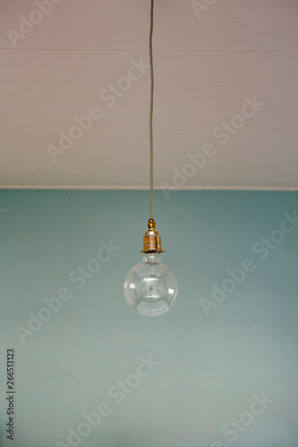 hanging light bulb blue pastel background. minimal concept. modern design