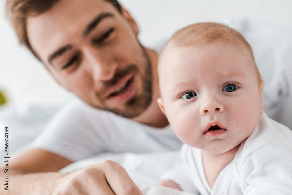 selective focus of bearded dad and curious baby selective focus of bearded dad and curious baby