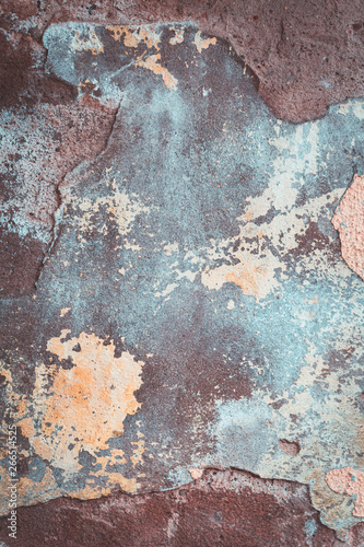 Old grungy cracked blue brown and yellow weathered wall paint peeling off the surface. Textured background for posters and bloggers, loft hipster concept