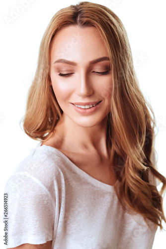 Portrait of emotive good-looking caucasian woman laughing while looking aside and standing against white background.