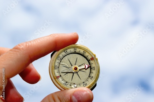A compass is an instrument used for navigation and orientation that shows direction relative to the geographic cardinal directions
