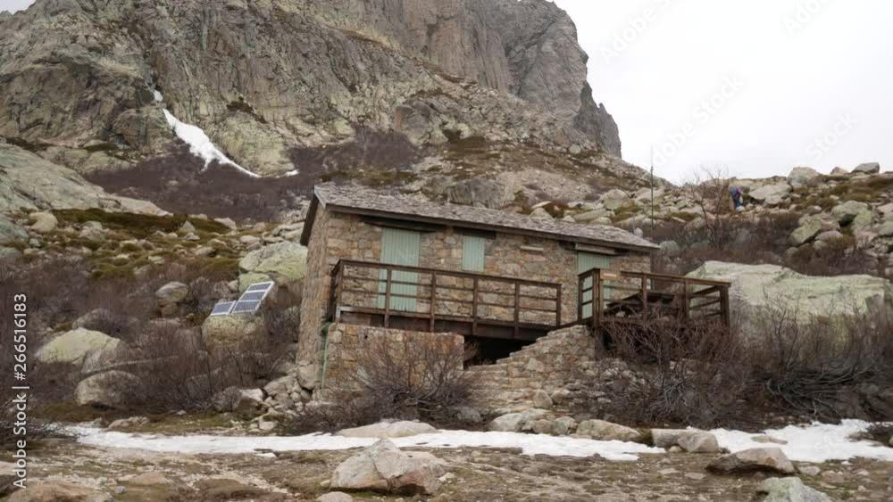 Lac de Melo, Corte, Haute-Corse, Corsica, France, Europe - April 22 2019: Alpine refuge (bivouac) and peaks of mountains in Restonica Valley Lac de Melo, Corte, Haute-Corse, Corsica, France, Europe - April 22 2019: Alpine refuge (bivouac) and peaks of mountains in Restonica Valley