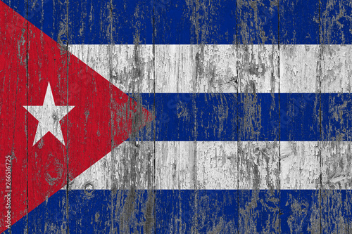 Flag of Cuba painted on worn out wooden texture background.