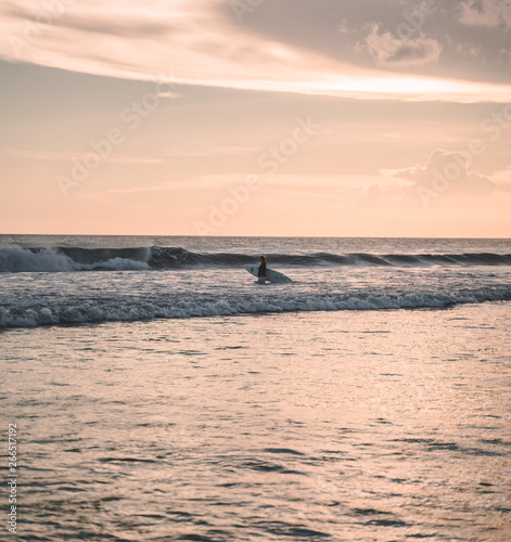 alone surfer at sunset 