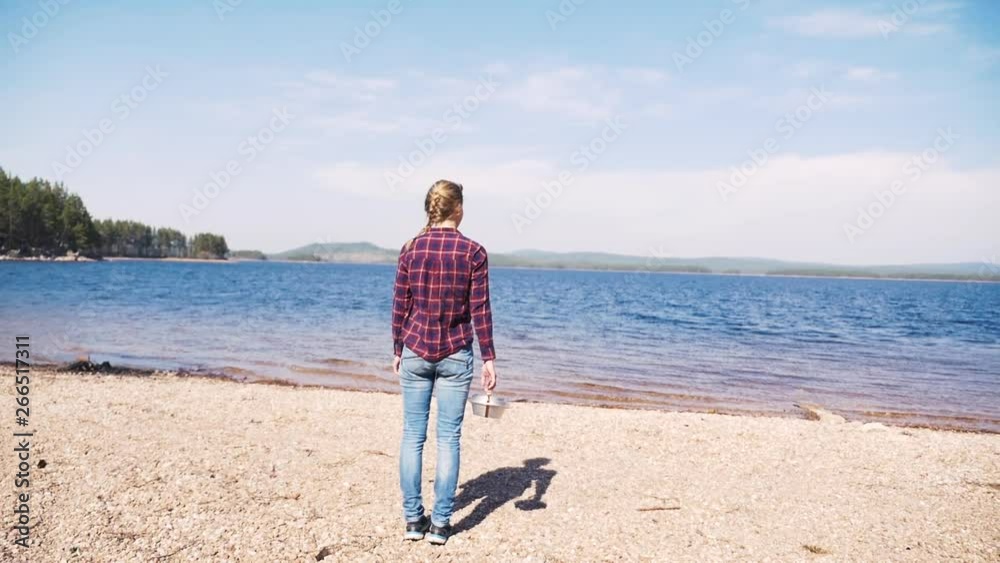 Swedish girl unpacking a Trangia portable stove on a sunny day at the lake. Part one. 60 fps Slowmotion. Swedish girl unpacking a Trangia portable stove on a sunny day at the lake. Part one. 60 fps Slowmotion.