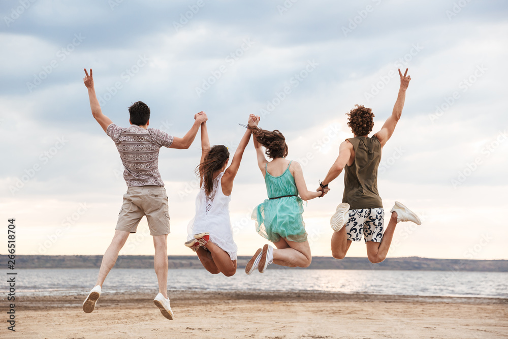 Group of a cheerful young friends jumping Group of a cheerful young friends jumping
