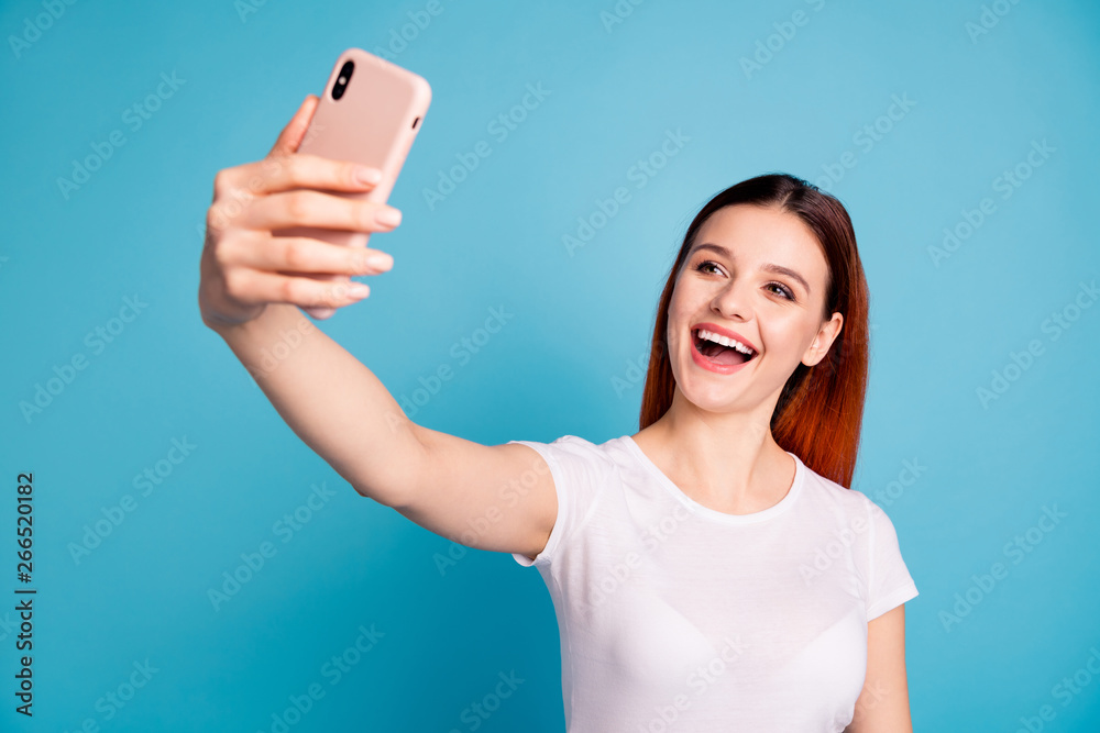 Close-up portrait of her she nice attractive lovely sweet winsome cheerful cheery glad girl wearing white tshirt taking making selfie isolated over bright vivid shine blue background Close-up portrait of her she nice attractive lovely sweet winsome cheerful cheery glad girl wearing white tshirt taking making selfie isolated over bright vivid shine blue background