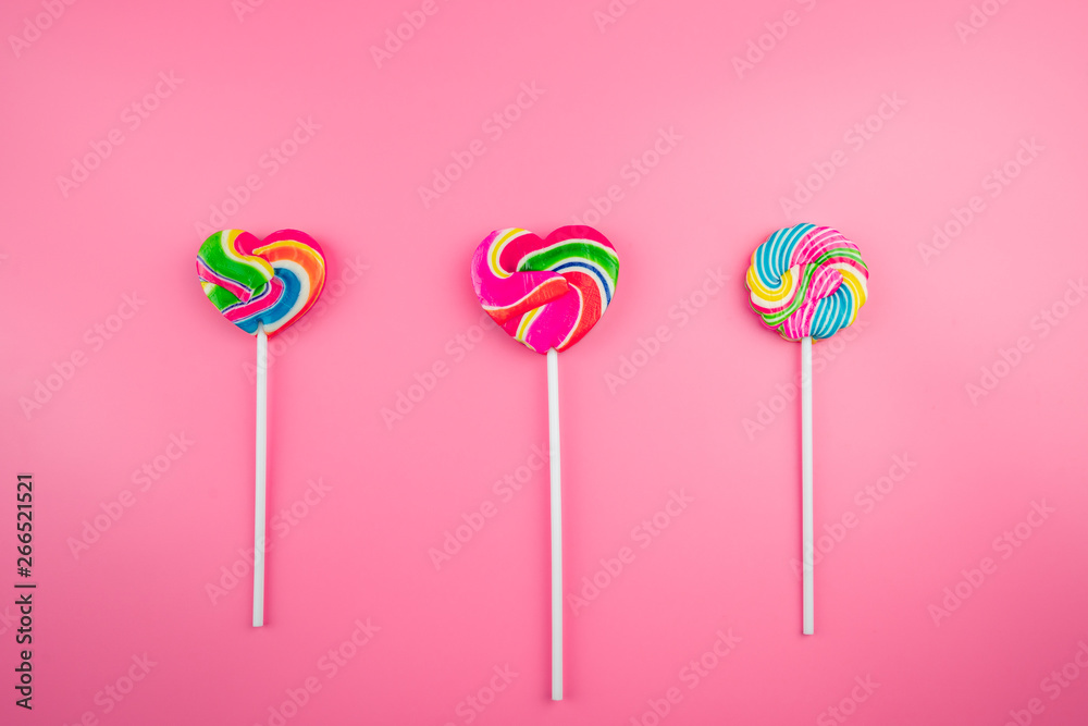 Multicolored lollipops on a pink background Multicolored lollipops on a pink background