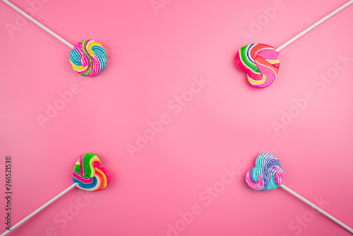 Multicolored lollipops on a pink background