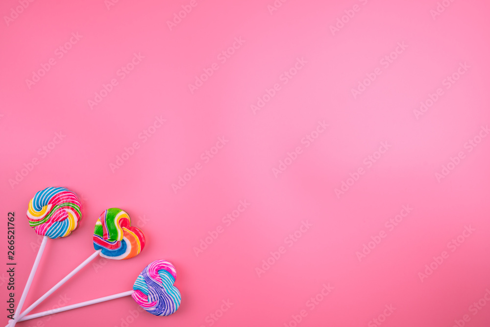 Multicolored lollipops on a pink background Multicolored lollipops on a pink background