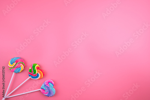 Multicolored lollipops on a pink background