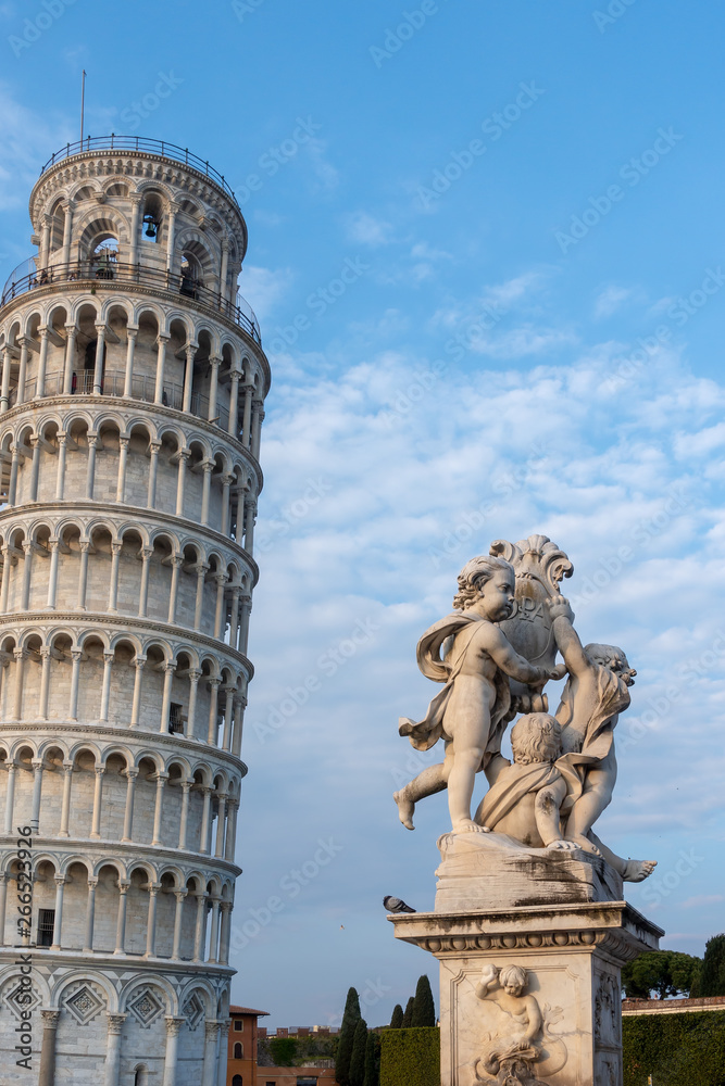 PISA, TUSCANY/ITALY  - APRIL 17 : Statue of cherubs in front of the Leaning Tower of Pisa Tuscany Italy on April 17, 2019. Unidentified people