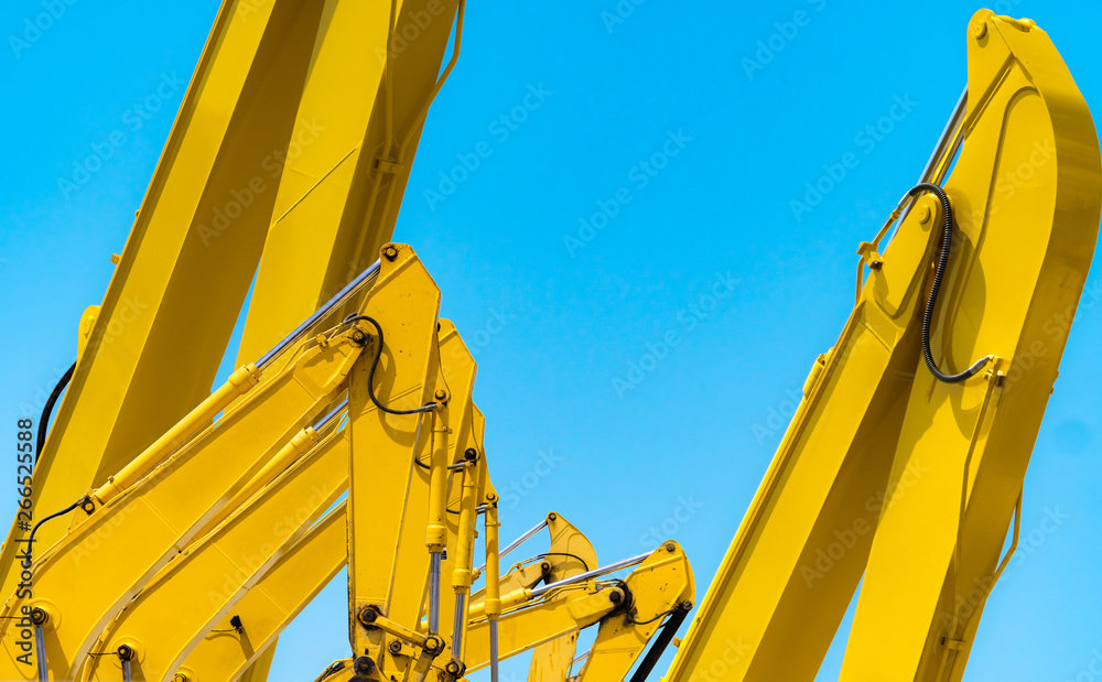 Yellow backhoe with hydraulic piston arm against clear blue sky. Heavy  machine for excavation in construction site. Hydraulic machinery. Huge  bulldozer. Heavy machine industry. Mechanical engineering. Stock Photo |  Adobe Stock