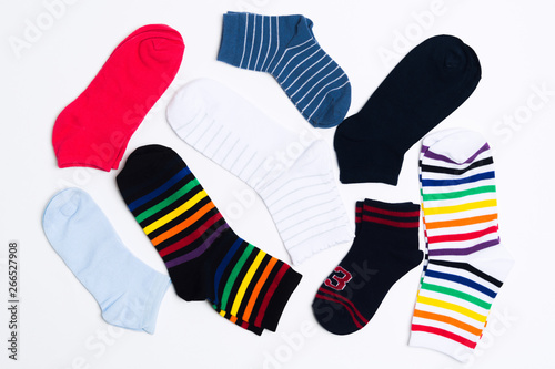 Many various colorful textile socks for warm weather. Legs clothes on white background
