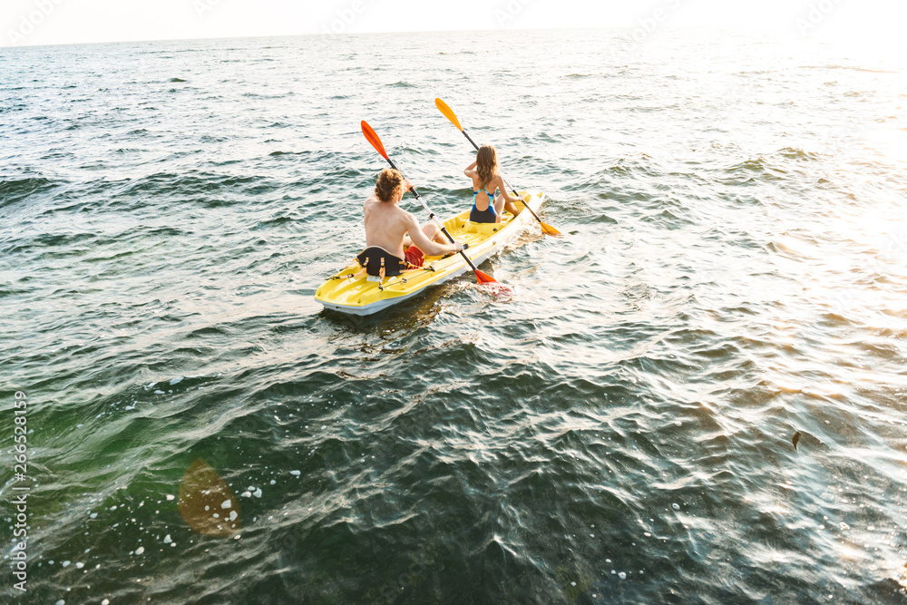 Sporty attractive couple kayaking