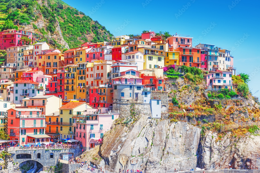 Italy, Manarola. Colorful houses on the moutain slope of medieval village Manarola in Cinque Terre national park on Ligurian sea shore of Italy. UNESCO world heritage site, iconic touristic landmark.