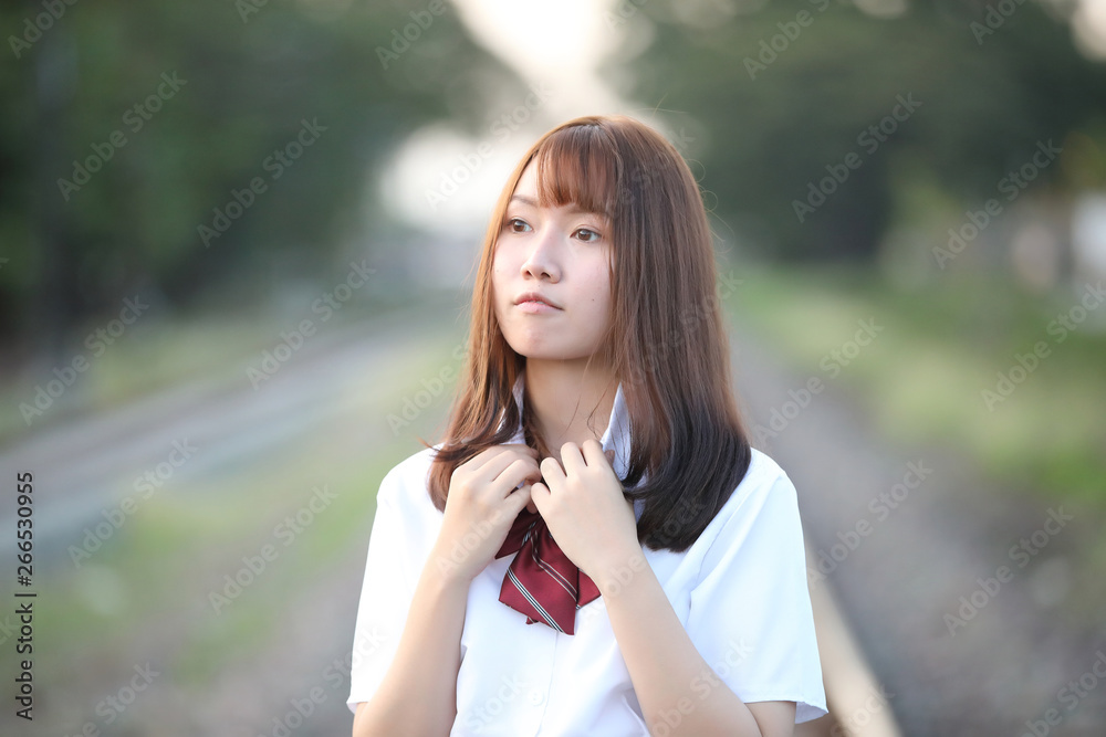 Portrait of asian japanese school girl costume looking at park outdoor film vintage style Portrait of asian japanese school girl costume looking at park outdoor film vintage style
